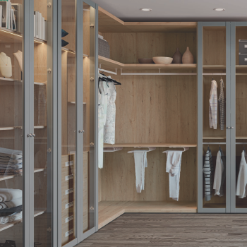 Armario moderno de madera con estantes y barras para colgar ropa, iluminación suave.